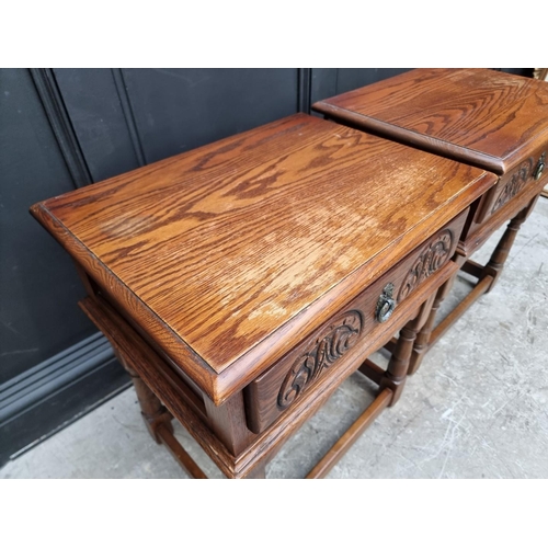 1007 - A pair of 'Old Charm' oak bedside tables, 56.5cm wide. (2)