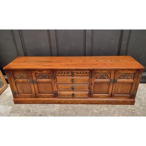 1009 - An 'Old Charm' oak low side cabinet, 183cm wide.