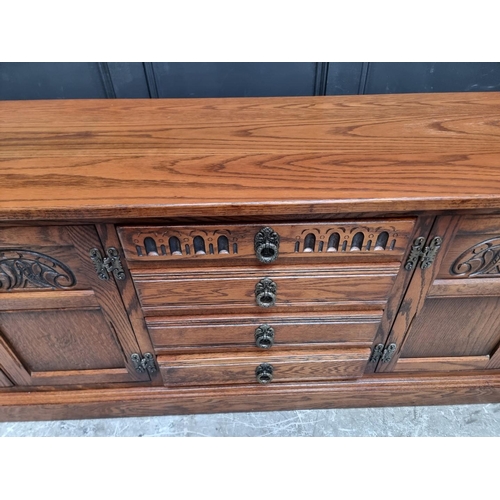 1009 - An 'Old Charm' oak low side cabinet, 183cm wide.