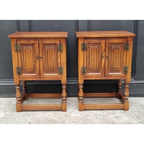 1016 - A pair of 'Old Charm' oak bedside cupboards, 50cm wide. (2)