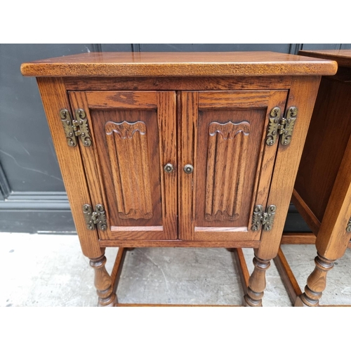 1016 - A pair of 'Old Charm' oak bedside cupboards, 50cm wide. (2)