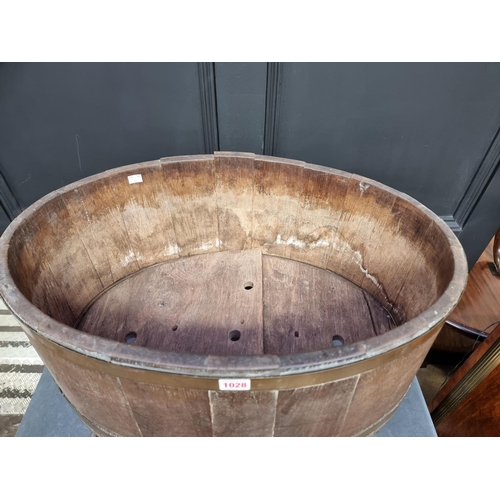 1028 - A large 19th century oak and brass bound oval wine cooler, the top 65cm wide.