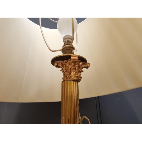 1030 - A brass and cast iron Corinthian column standard lamp, height excluding fitting 158cm.... 