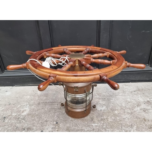 1032 - A novelty teak ship's wheel and copper lantern coffee table, with glass top, 100cm diameter.... 