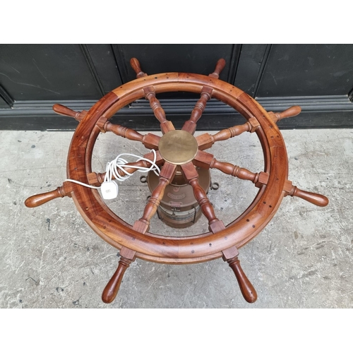 1032 - A novelty teak ship's wheel and copper lantern coffee table, with glass top, 100cm diameter.... 