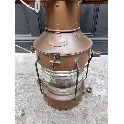 1032 - A novelty teak ship's wheel and copper lantern coffee table, with glass top, 100cm diameter.... 