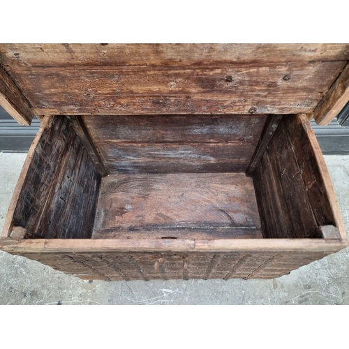 1033 - An Indian hardwood and metal bound trunk, with shallow domed top, 77cm wide.