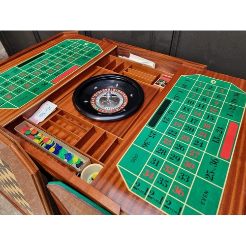 1038 - An Italian marquetry games table, incorporating a roulette wheel, backgammon and chequerboard, 74cm ... 