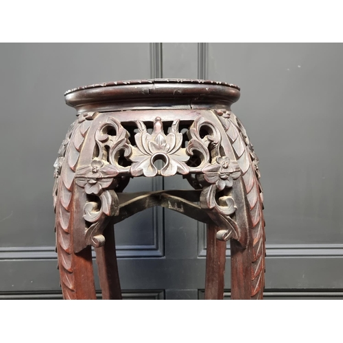 1042 - A Chinese carved hardwood and marble inset jardiniere stand, 91cm high.