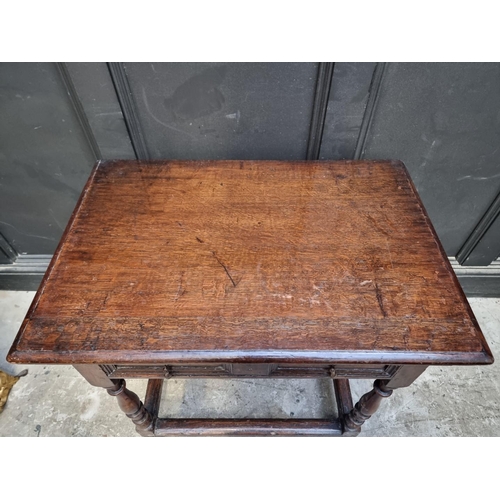 1044 - An early 18th century oak single drawer side table, 81cm wide, (feet replaced).