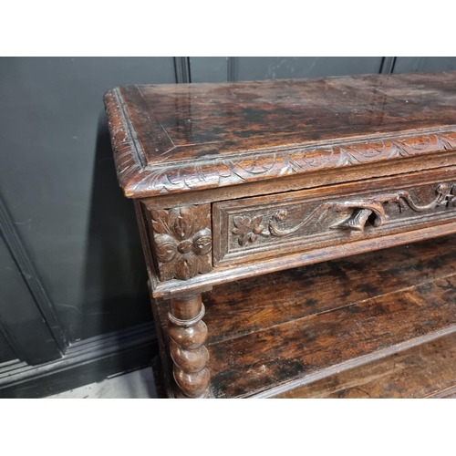 1050 - A late Victorian carved oak three tier buffet, 120cm wide.