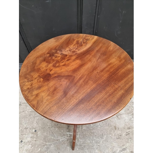 1055 - A George III mahogany circular tilt-top tripod wine table, 50cm diameter, (repairs to two legs)... 