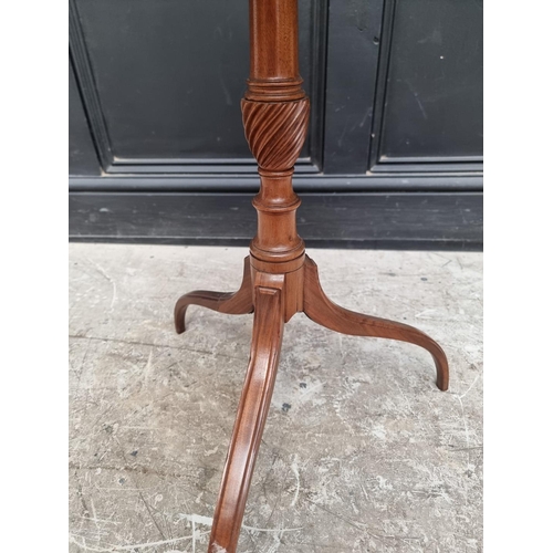 1055 - A George III mahogany circular tilt-top tripod wine table, 50cm diameter, (repairs to two legs)... 