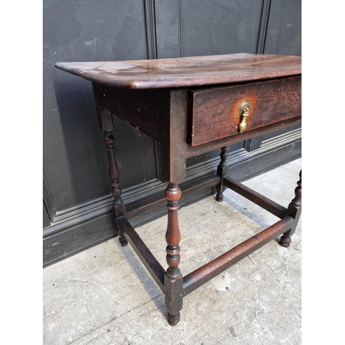 1061 - An early 18th century oak single drawer side table, 77.5cm wide.