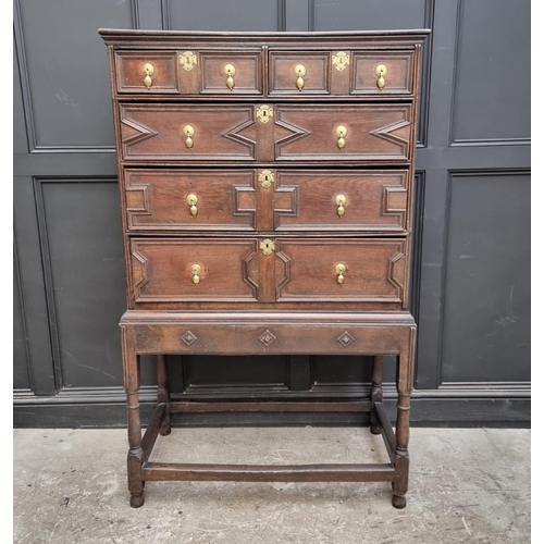 1063 - An antique oak geometrically moulded chest on stand, 102.5cm wide.