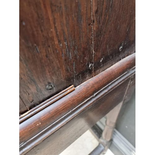 1063 - An antique oak geometrically moulded chest on stand, 102.5cm wide.