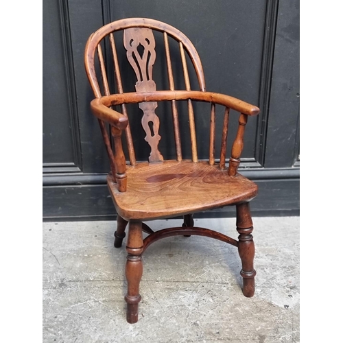 1070 - A scarce 19th century yew, elm and fruitwood childs' Windsor armchair.