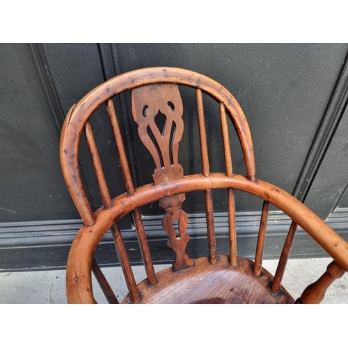 1070 - A scarce 19th century yew, elm and fruitwood childs' Windsor armchair.