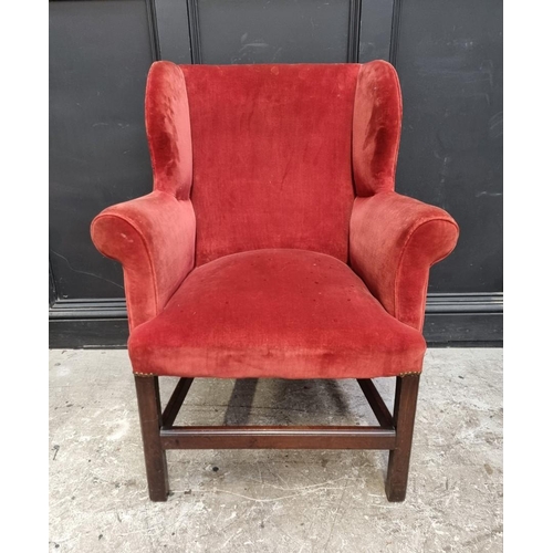 1075 - A small antique mahogany wing armchair. 