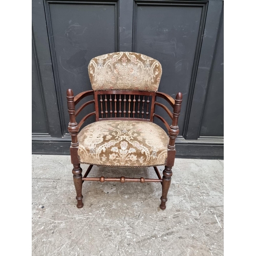 1076 - An unusual Edwardian mahogany and upholstered tub armchair. 