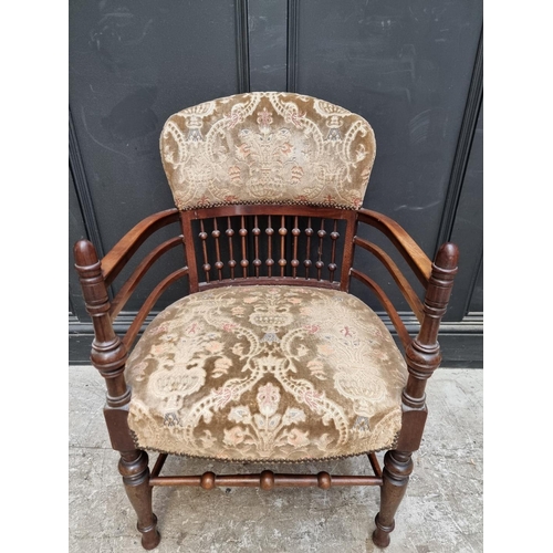 1076 - An unusual Edwardian mahogany and upholstered tub armchair. 