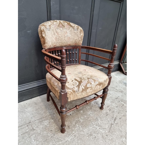 1076 - An unusual Edwardian mahogany and upholstered tub armchair. 