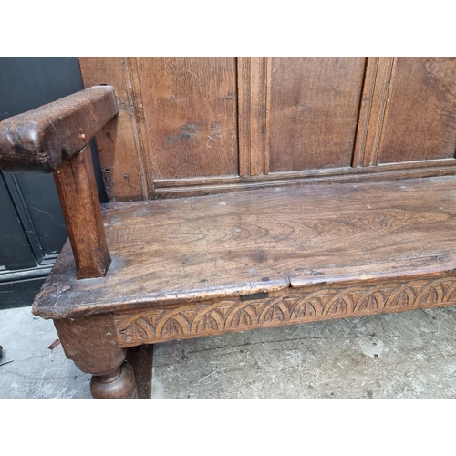 1080 - An antique oak and elm settle, 156cm wide.