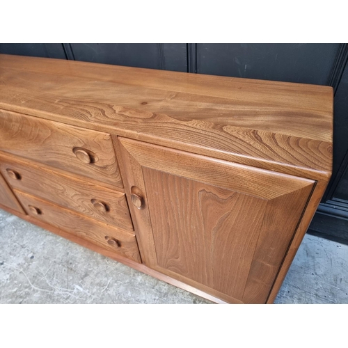 1090 - A vintage Ercol elm side cabinet, 155.5cm wide.