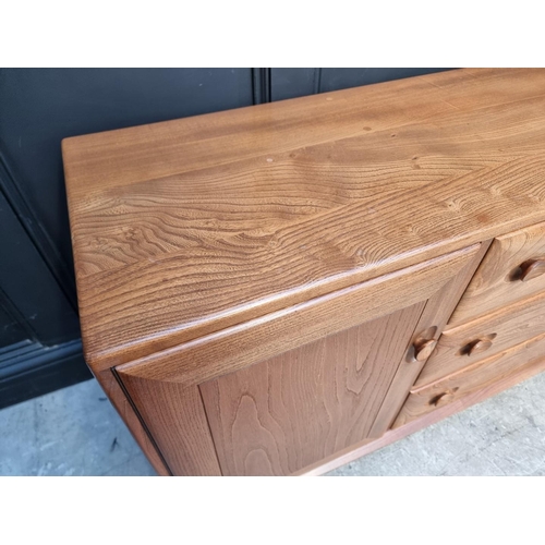 1090 - A vintage Ercol elm side cabinet, 155.5cm wide.