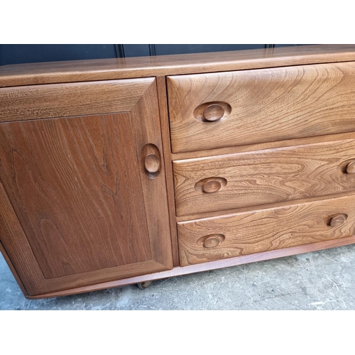 1090 - A vintage Ercol elm side cabinet, 155.5cm wide.