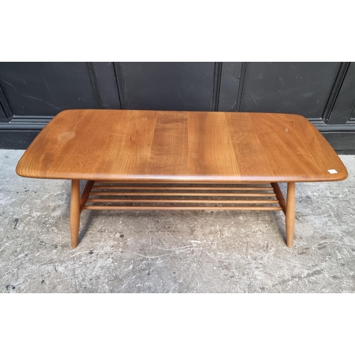 1091 - A vintage Ercol elm low occasional table, with spindle under tier, 104cm wide.