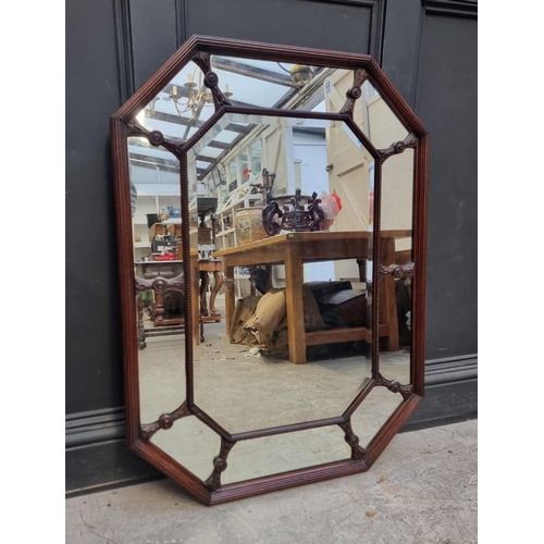 1095 - An Edwardian carved mahogany framed octagonal wall mirror, 106 x 78cm.