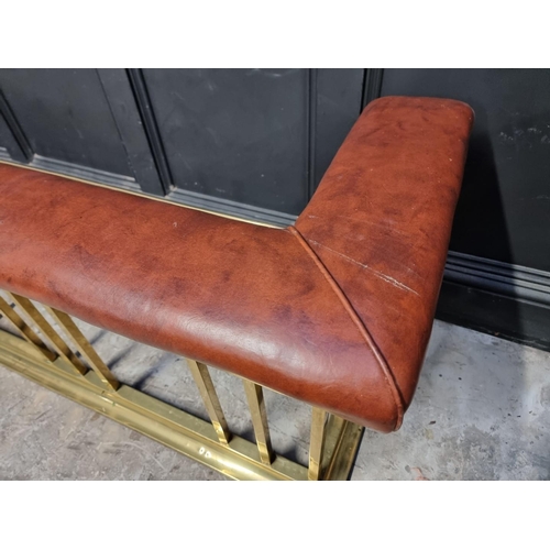 1103 - A large brass and tan leather club fender, 190cm wide.