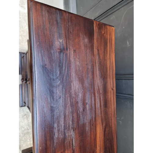 1107 - A reproduction stained hardwood pedestal desk, 152cm wide.