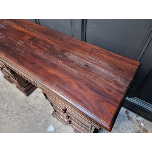 1107 - A reproduction stained hardwood pedestal desk, 152cm wide.