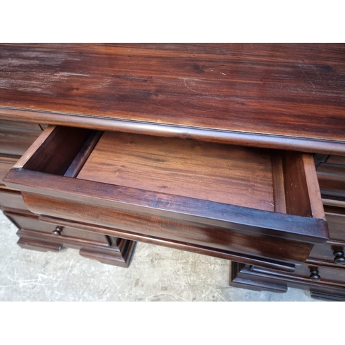 1107 - A reproduction stained hardwood pedestal desk, 152cm wide.