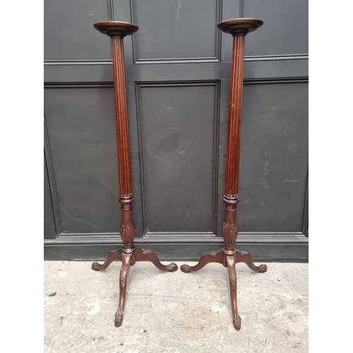 1109 - A pair of mahogany 'bedpost' tripod torcheres, 143.5cm high. (2)