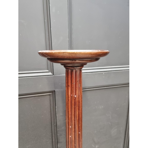 1109 - A pair of mahogany 'bedpost' tripod torcheres, 143.5cm high. (2)