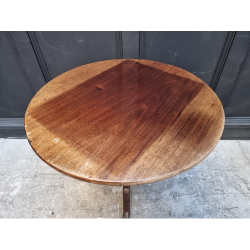 1111 - A George III mahogany circular tilt-top tripod table, 77cm diameter.