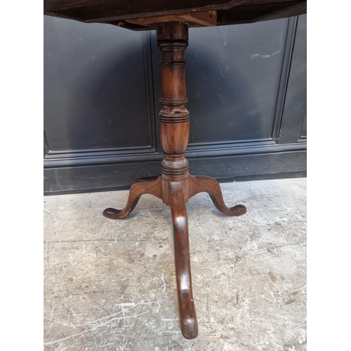 1111 - A George III mahogany circular tilt-top tripod table, 77cm diameter.