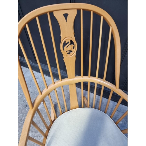 1115 - An Ercol swan back rocking chair.