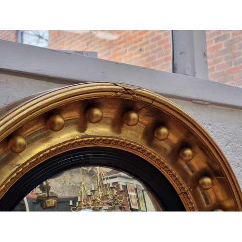 1118 - A 19th century gilt convex wall mirror, 56.5cm diameter.