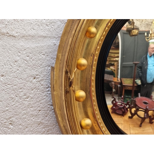 1118 - A 19th century gilt convex wall mirror, 56.5cm diameter.