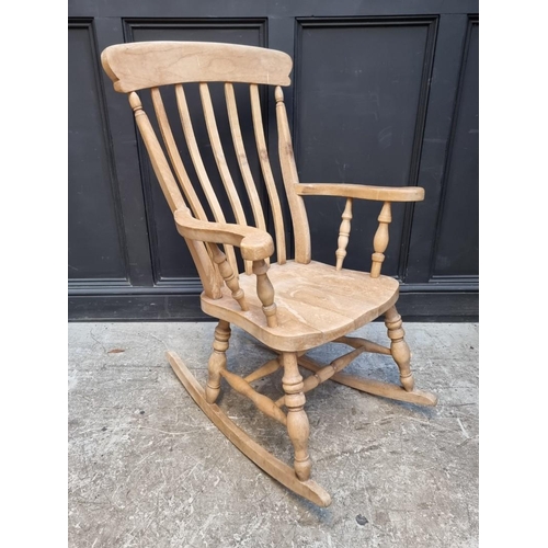 1127 - A beechwood lath back rocking chair.