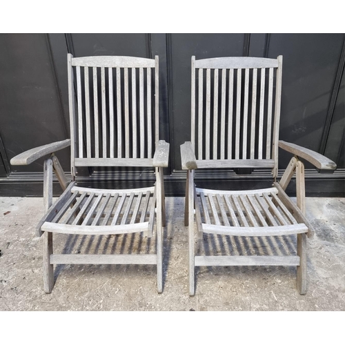 1136 - A pair of teak garden steamer chairs. (2)