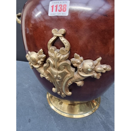 1138 - A turned wood and brass mounted twin handled jar and cover, 46cm high.