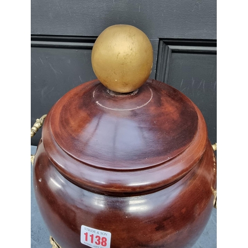 1138 - A turned wood and brass mounted twin handled jar and cover, 46cm high.