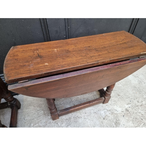 1139 - A small reproduction oak joint stool, with drawer, 48cm wide; together with a similar drop leaf tabl... 