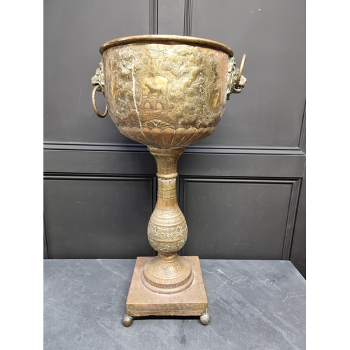 1174 - A Dutch embossed brass pedestal jardiniere, 81cm high.