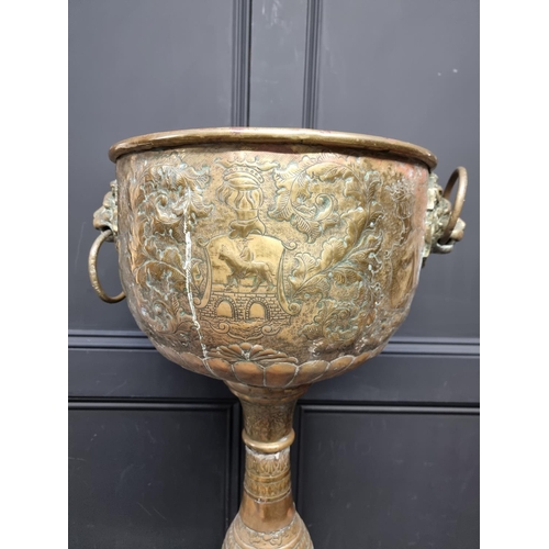 1174 - A Dutch embossed brass pedestal jardiniere, 81cm high.